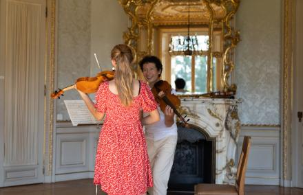 Eine engagierte Lehrkraft fordert Elan im Spiel der Violine von einer Schülerin